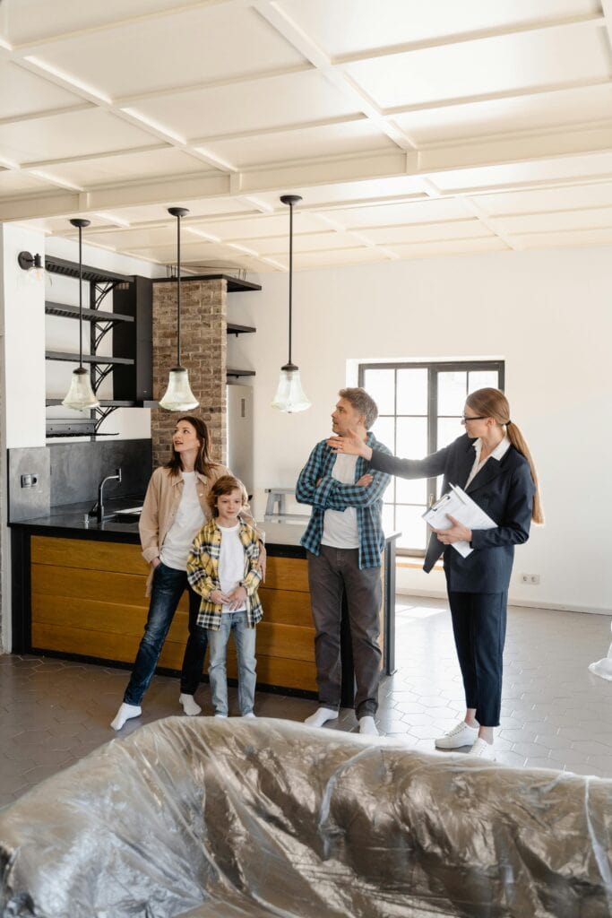 A family being shown a home by a realtor